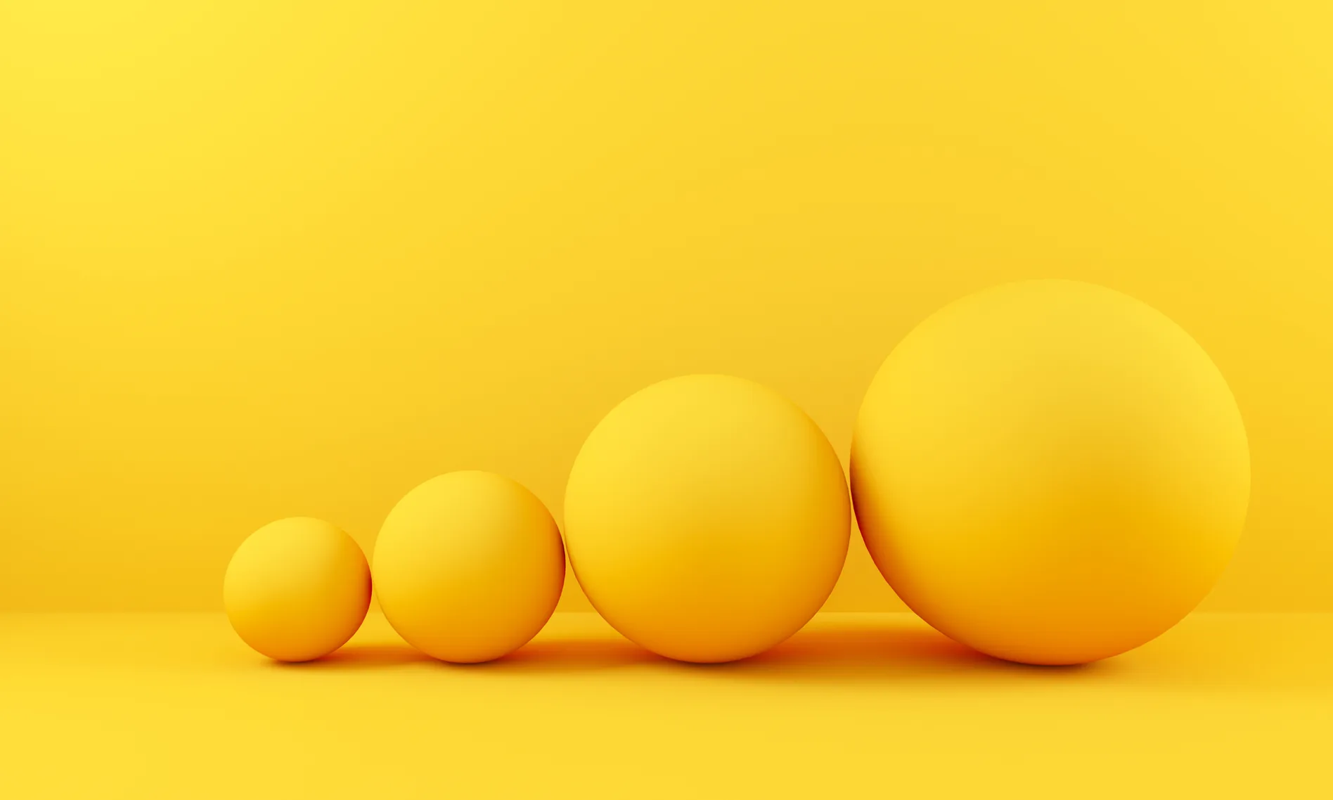 Yellow spheres of increasing size on a yellow background