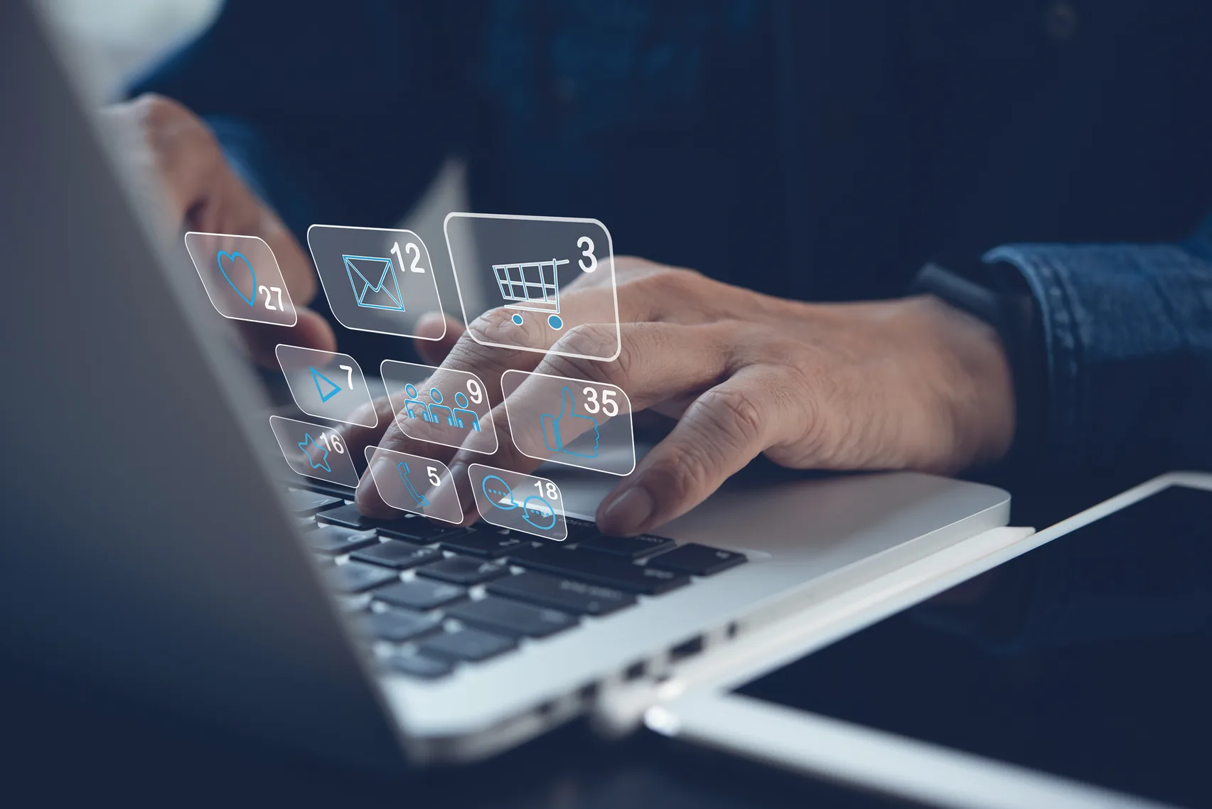 Hands typing on a laptop surrounded by floating app icons