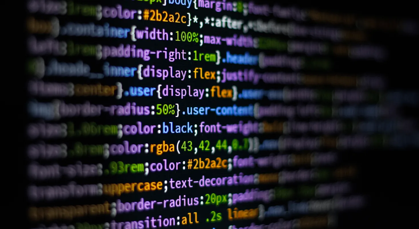 Close-up of colorful code on a dark screen