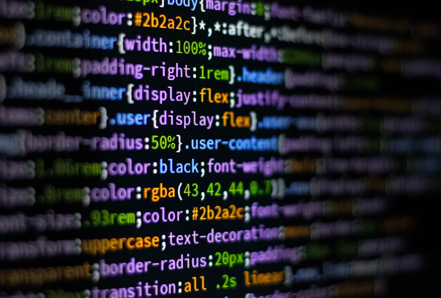 Close-up of colorful code on a dark screen